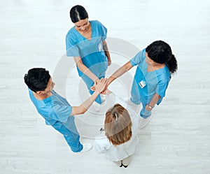 Above, teamwork or hands of doctors in stack in meeting collaboration for healthcare targets or goals. About us, team