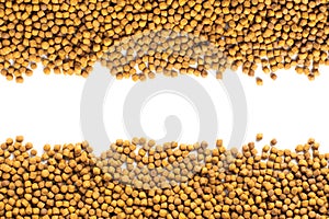 Above or Top view of animal food. Brown Dried dog food on white background. Grain pet food banner background with copy space for