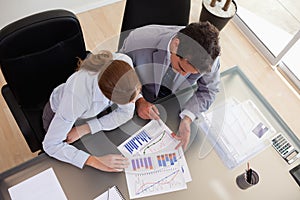 Above view of consultant analyzing data with her client