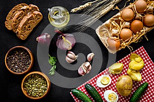Above view of country dinner table with effs, bread, potatoes