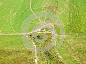 Above view of country roads in green winter fields