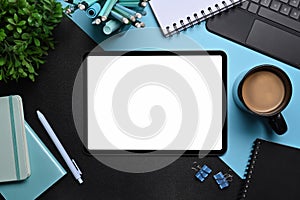 Creative designer workspace with digital tablet, laptop and supplies.