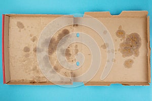 Above view of greasy empty delivery pizza box