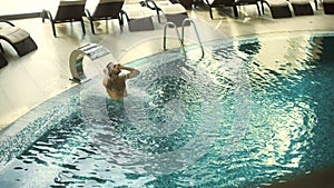 Above view of handsome man enjoying water jet. Guy getting water treatment.