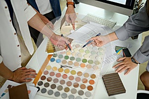 Above view of Interior designer team working with color swatches on meeting table