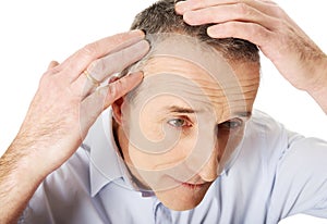 Above view of a man examining his hair