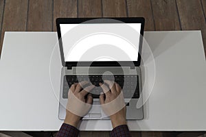 Above view of man typing on a laptop