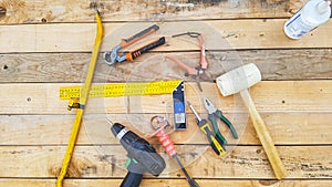 Above view of mixed hardware stuffs on a wood table maded by recycled pallets. do it yourself repair and contruct furnitures like