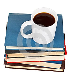 Above view of mug of coffee on stack of books