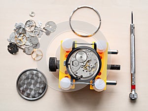 above view of open watch in yellow holder on table