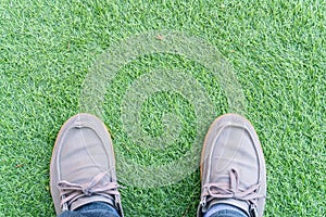 above view sneakers shoes on a green artificial grass