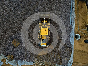 Above view of tractor doing earthwork in spring. Above view