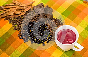 Above view of traditional Ecuadorian dish, colada morada and differente species over a colorful fabric