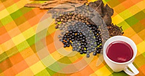 Above view of traditional Ecuadorian dish, colada morada and differente species over a colorful fabric