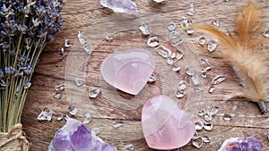 Above view of two polished pink color rose quartz crystals on wood tray in home.