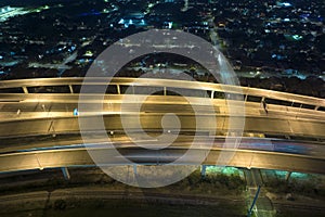 Above view of wide highway crossroads in Tampa, Florida at night with fast driving cars. USA transportation