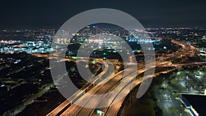 Above view of wide highway crossroads in Tampa, Florida at night with fast driving cars. USA transportation