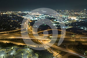 Above view of wide highway crossroads in Tampa, Florida at night with fast driving cars. USA transportation