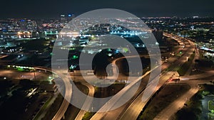 Above view of wide highway crossroads in Tampa, Florida at night with fast driving cars. USA transportation