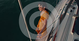 Above, view and a woman on a yacht for vacation, relax and travel during summer. Sailing, peace and a girl standing on a