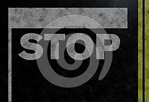 Above view of word STOP and stop bar on asphalt