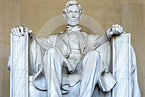Abraham Lincoln seated in an armchair in the temple and monument in his honor on the National Mall in Washington DC.