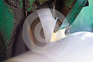 Abrasive grinding wheel on the machine close-up.