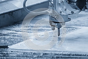 The abrasive waterjet cutting machine in the light blue scene photo