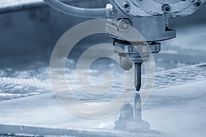 The abrasive waterjet cutting machine in the light blue scene photo