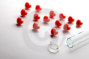 Abriveura IVF from red hearts and a broken test tube in the foreground. Concept of unsuccessful in vitro fertilization. The theme