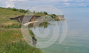 Abrupt riverside on covered with greenish cyanobacterias Dnipro river near Skelky village, Zaporizhia Oblast, Ukraine