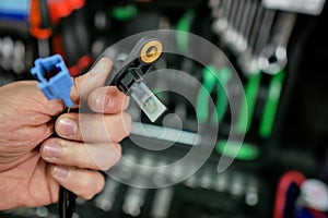 ABS sensor in the hands of an auto mechanic. photo