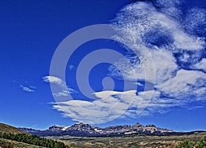 Absaroka Mountain Range under summer cirrus and lenticular clouds near Dubois Wyoming photo