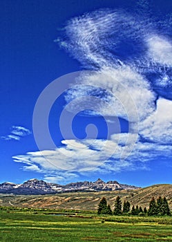 Absaroka Mountain Range under summer cirrus and lenticular clouds near Dubois Wyoming photo
