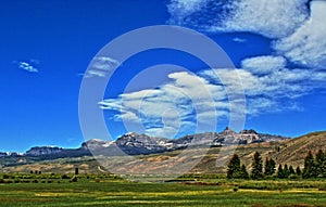 Absaroka Mountain Range under summer cirrus and lenticular clouds near Dubois Wyoming photo