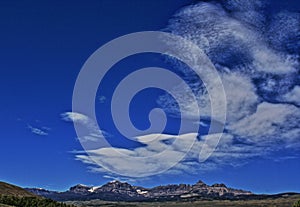 Absaroka Mountain Range under summer cirrus and lenticular clouds near Dubois Wyoming photo