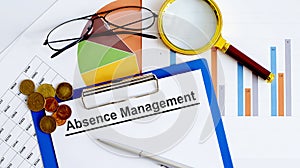 ABSENCE MANAGEMENT Business reports, blank paper , data tables and charts,magnifier,coins - directly above view of office table