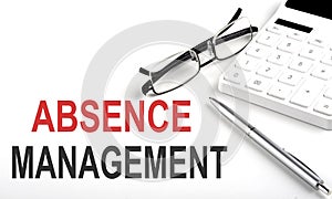 ABSENCE MANAGEMENT Concept. Calculator,pen and glasses on the white background