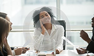 Absent-minded distracted black businesswoman dreaming smiling at