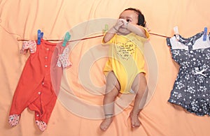 Absentminded Mother hangs child on clothesline