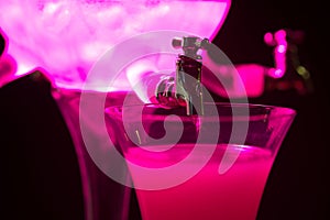 Absinth glass and fountain in pink