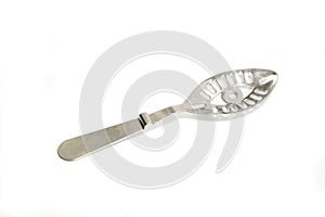 Absinth spoon with orifices on white background