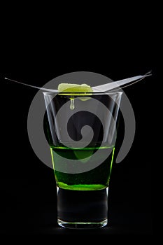 Absinthe with dropping sugar photo