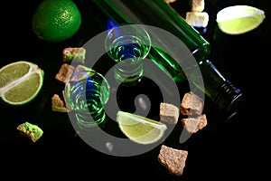 Absinthe poured into a glass. absinthe shots with sugar cubes. Bottle of absinthe and glasses with burning. free space for text.