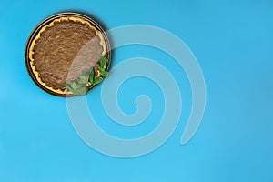 Absolutely amazing Thanksgiving background. Manmade pumpkin pie with fresh mint leaves on light blue background with copy space