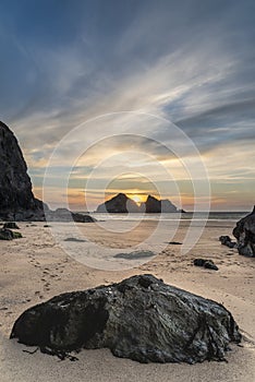 Absolutely beautiful landscape images of Holywell Bay beach in Cornwall UK during golden hojur sunset in Spring