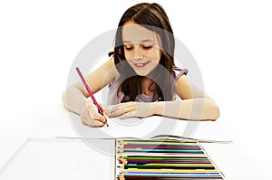 Absorbed little girl drawing with colorful pencils photo
