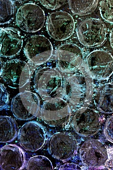 Absract background of shiny plastic and bubbles dreating bright sci-fi style texture background