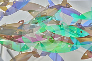 Abstact background of hanging fish of holographic trendy colors
