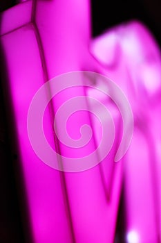 Abstact blurred Plastic pink sign on black background